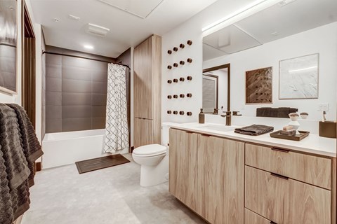 A bathroom with a toilet, sink, and a shower with a glass door.